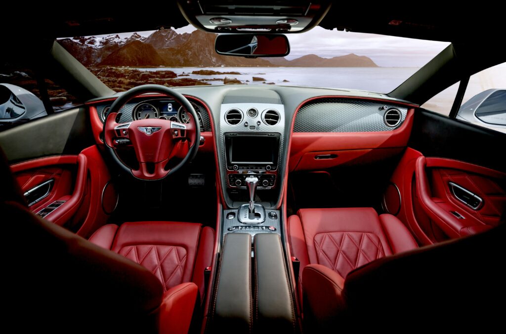 pexels photo 326259 326259 Red leather luxury sports car interior with mountain backdrop outside the window.